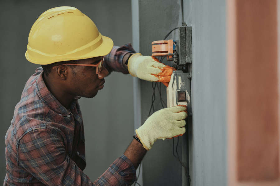 A guy installing the switch for the inverter